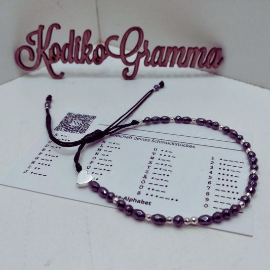 Makramee-Armband mit Morsecode-Botschaft „Gute Besserung“ aus schwarzen und silbernen Hämatitperlen.